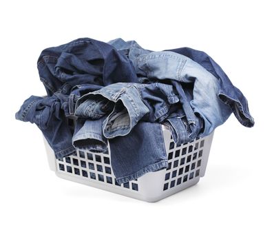A Laundy basket filled with only jeans. Isolated on white with natural shadows.