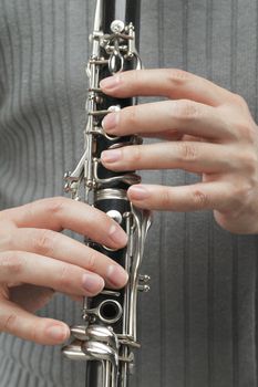 Man playing Clarinet, a woodwind instrument.