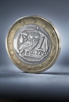 A worn and dirty Greek Euro coin. Short depth of field.