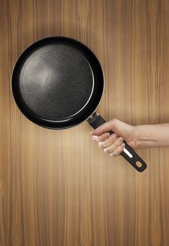 Man holding a saucepan which has a ceramic non-stick coating