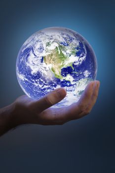Man holding a glowing earth in his hand. Earth image provided by NASA.