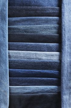 Denim jeans fabric background made of different blue fabrics