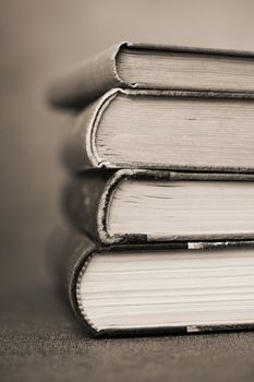 Sepia toned image of stacked old books