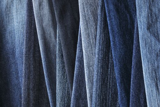 Background image of different blue denim jeans fabrics