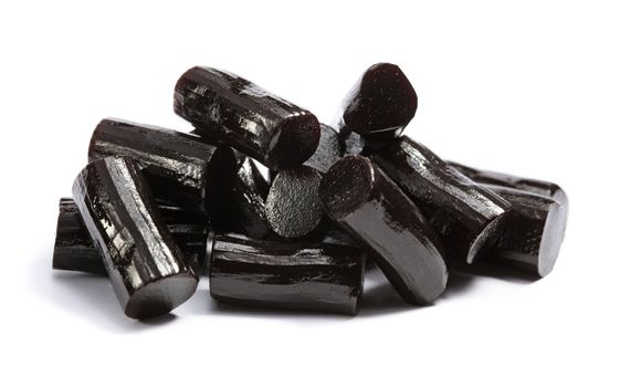 Pieces of black liquorice on white