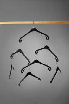 Empty black plastic clothes hangers hanging