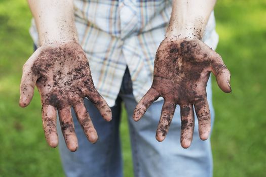 A Man showing dirty hands after gardening work