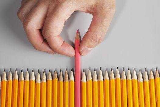 Hand choosing a pink pencil