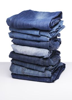 A Stack of old blue jeans pants.