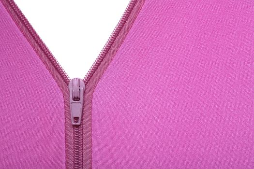 Zipper of a fuchsia colored garment revealing a white surface