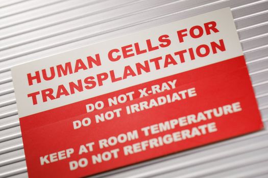 Human Cells for Transplantation information sticker. Short depth-of-field.