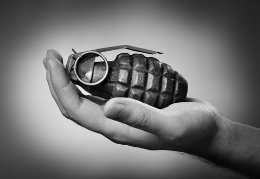 Man holding a hand grenade on his hand.