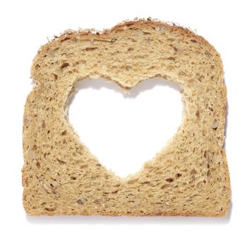 Heart shaped hole in a slice of bread