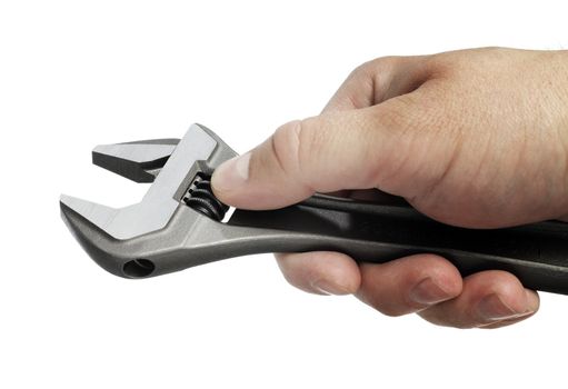 Man adjusting an adjustable wrench in his hand.