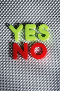 the words YES and NO written with plastic toy letters