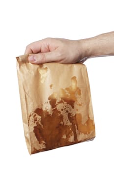 Man holding a brown paper bag with very greasy contents