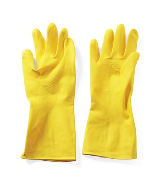 Yellow household protective rubber gloves on white