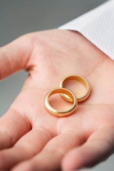 Old golden wedding rings on a man's hand