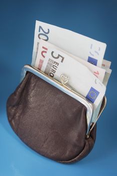 Euro money in an old leather purse