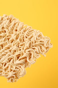 Dry ramen instant noodles with yellow background