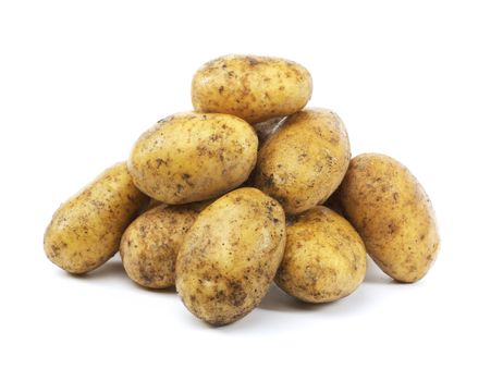 A Heap of harvested dirty potatoes on white