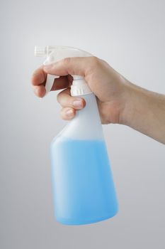 A Hand holding a spray bottle