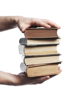 Man carrying a stack of book in his hands