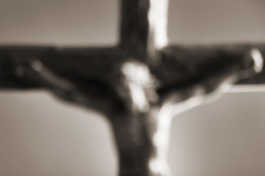 A defocused blurry image of a crucifix