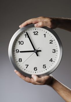 Man holding a clock in his hands