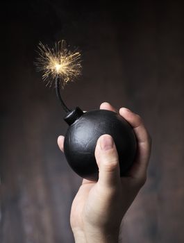 Man holding a bomb in his hand, ready for a throw