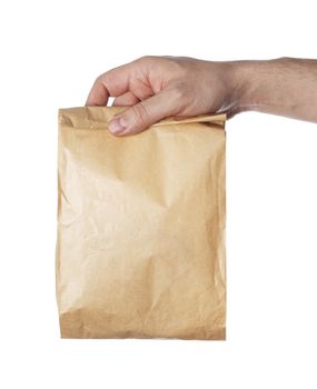 Man holding a brown paper bag in his hand.