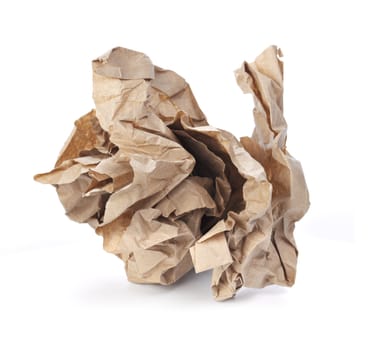 Crumpled brown paper isolated on white with natural shadows