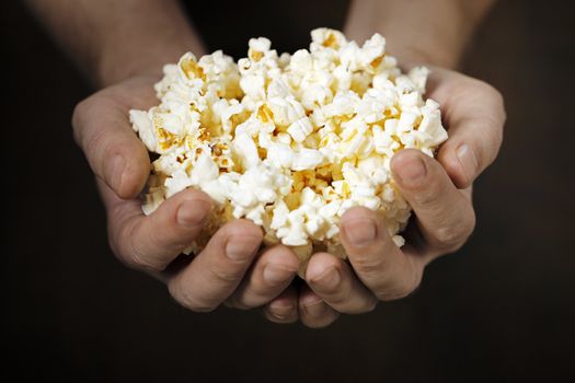 Man holding pop corn in his hands