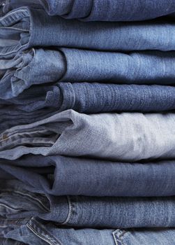 Different shades of blue jeans stacked