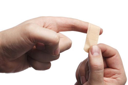 Man putting on an adhesive bandage