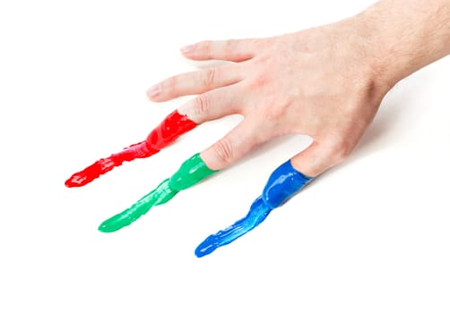 Fingers with fingerpaints in three primary colors, Red, green and blue.