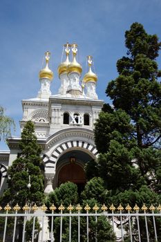 Four golden cupolas of russian eastern orthodox church by beautiful weather in Geneva, Switzerland.