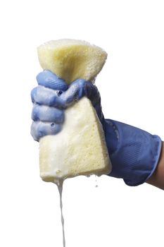 Hand holding a yellow sponge dripping with soapy water