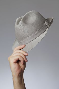 Man holding a vintage trilby hat in his hand