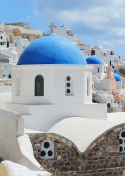 Famous Blue Domes of orthodox churches in the caldera background at Santorini island, Greece.