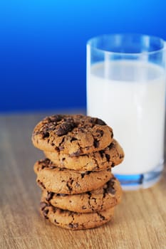 Stack of chocolate chip cookies and a glass of milk. Short depth-of-field