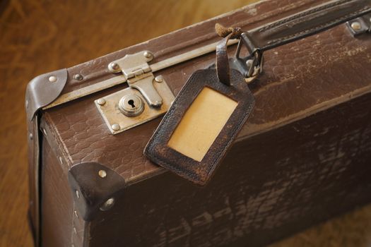 An old suitcase with a luggage tag.