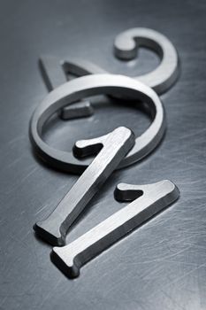 Metallic letters that can be used for number "2011" on scratched metallic background. Short depth of field.