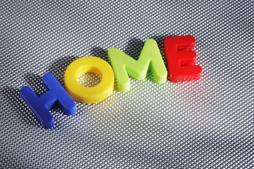 The word HOME spelled with plastic letters