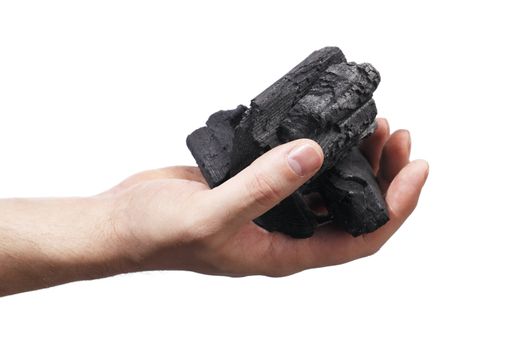 Man holding lumps of charcoal in his hand