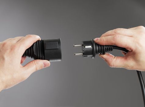 Man connecting an european shielded extension cord