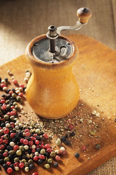 Old Pepper grinder mill with different dried peppers