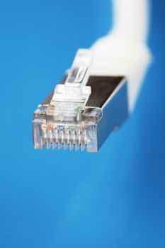 White shielded cat5 cable on blue