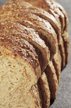 Sliced wheat bread on grey