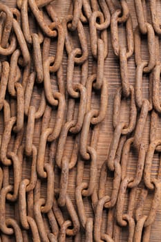 Old rusty chain on wooden background
